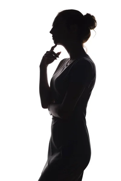 Silhouette of a pensive woman with the hand at the chin on a white isolated background, girl make a decision — Stock Photo, Image