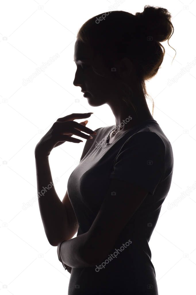 silhouette of a calm young woman on a white isolated background, figure of slim pensive girl