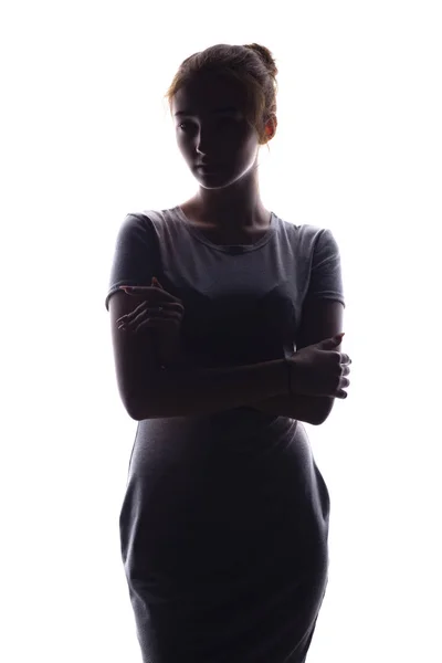 Silhouette di una bella ragazza fiduciosamente guardando avanti, figura di giovane donna su uno sfondo bianco isolato — Foto Stock