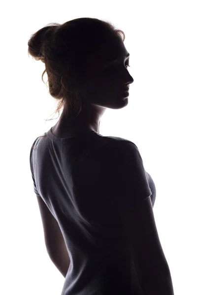 Figura de una sensual joven de pie atrás y dando la vuelta, una hermosa chica con el pelo recogido a mano sobre un fondo blanco aislado — Foto de Stock