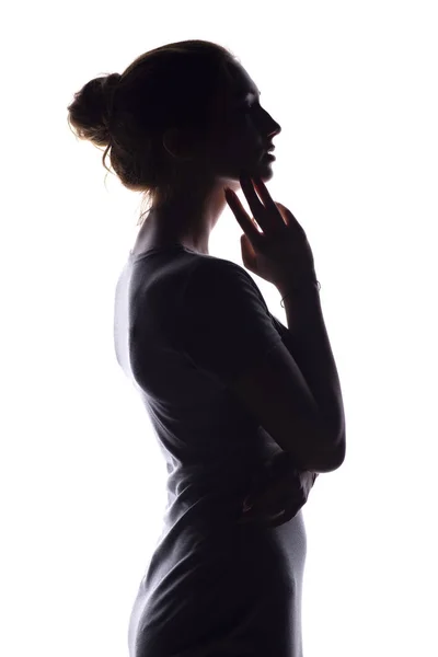 Silhueta de uma jovem calma em um fundo isolado branco, figura de menina pensiva magro — Fotografia de Stock