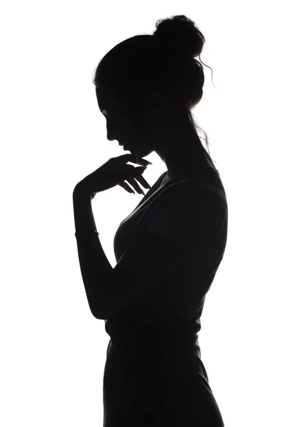 Silhouette profile of a sad woman with hand near chin on a white isolated background — Stock Photo, Image