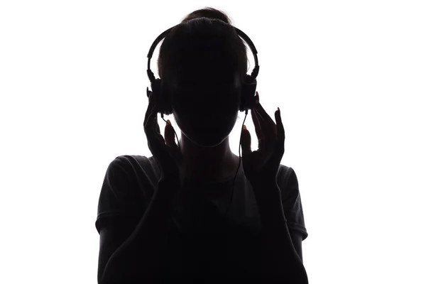 ヘッドフォンで音楽を聴く少女のシルエット、白い孤立した背景でリラックス若い女性 — ストック写真