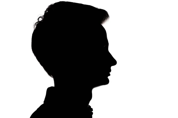 Silhouette di un ragazzo irriconoscibile, profilo volto uomo su un bianco — Foto Stock