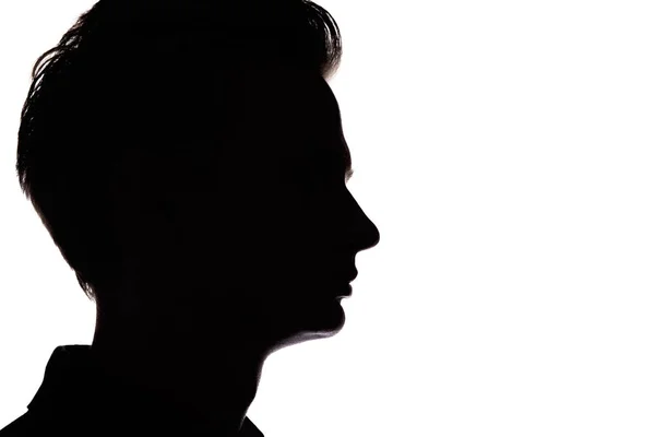Silhouette di un ragazzo irriconoscibile, profilo volto uomo su uno sfondo bianco isolato — Foto Stock