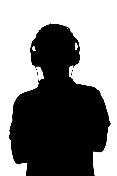 Silhouette d'adolescent écoutant de la musique dans les écouteurs, l'homme a plié les bras sur la poitrine sur fond blanc isolé — Photo