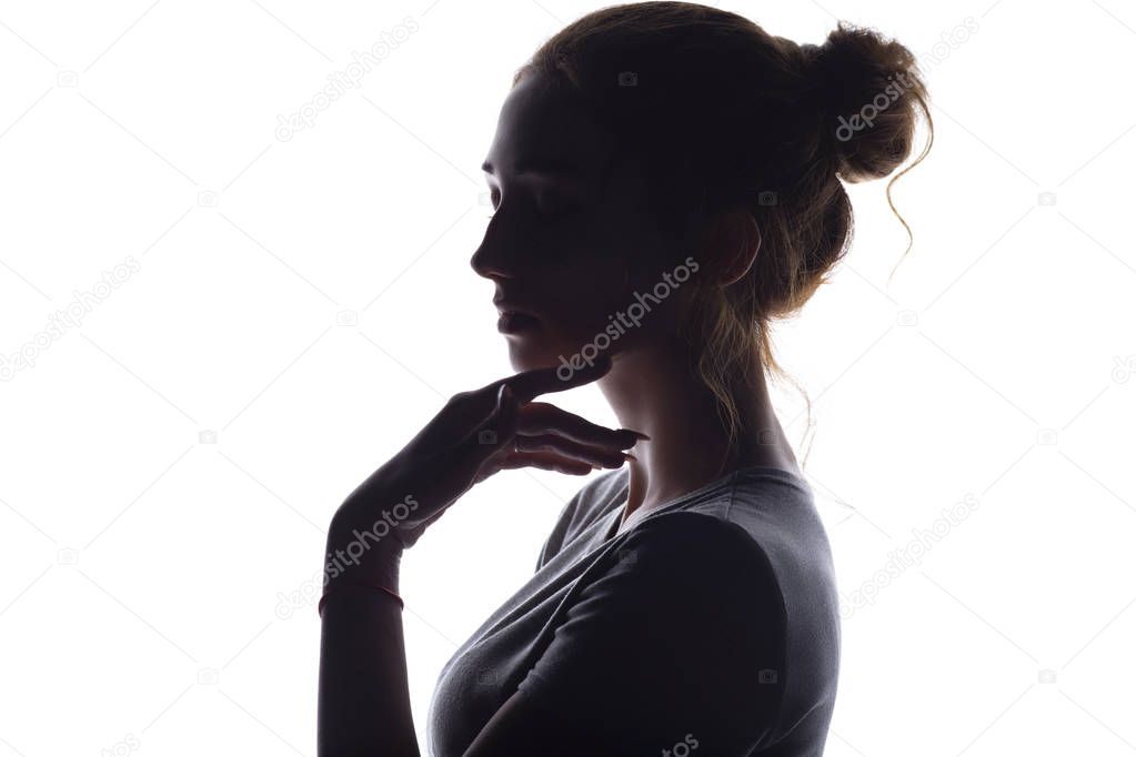 profile of beautiful girl with hand-picked hair, silhouette of a woman on a white isolated background