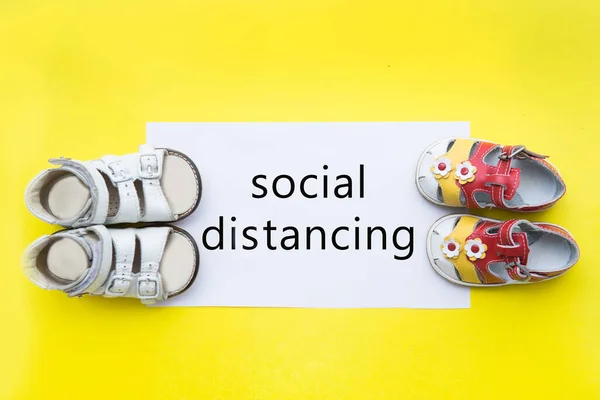 Social distance. Children\'s shoes at a distance from each other for social distance, increasing the physical space between people to avoid the spread of the disease during transmission of the COVID-19 outbreak