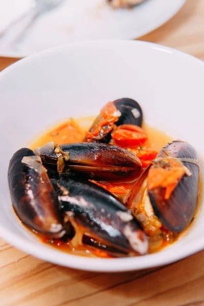 Tomato soup with mussels. The process of cooking tomato soup from mussels in a cooking class. Home-made food, home-made chef.