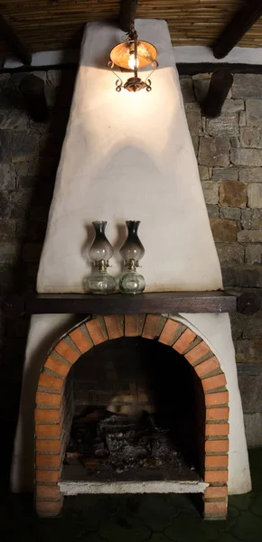 interior of hostel decorated with fireplace and old lamps