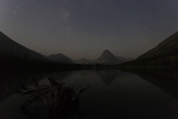 night view of the lake mountains sky and milky way