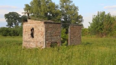 Tarlanın ortasındaki harabe ev. Terk edilmiş ev, ağaçlarla büyümüş. Kıyamet sonrası. Tuğla dansı kalıntıları. Tarlanın ortasında terk edilmiş harabe ev. Binanın kalıntıları. Çernobil. Dışlama Bölgesi. Çernobil bölgesi.