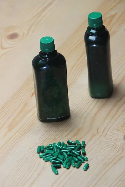 Pilules Capsules Vertes Bouteille Sirop Vitamine Verte Sur Fond Bois — Photo