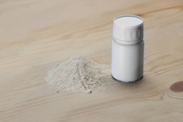 stock image Herbal powder with the spoon on wooden background.