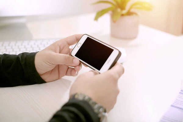 Picture of the man holding the smartphone.