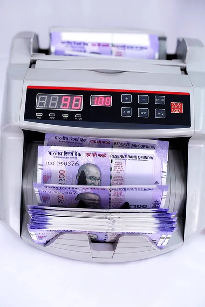 Money counting machine for counting new Indian currency. Isolated on the white background.