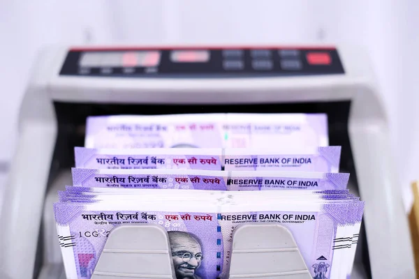 Indian banknote on Money counting machine. Isolated on the white background.