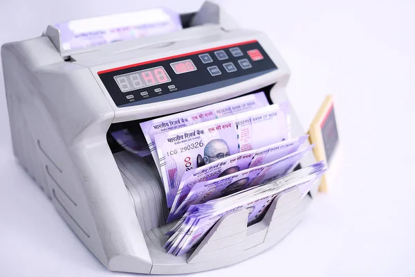 Counting currency in the money counting machine. Isolated on the white background.