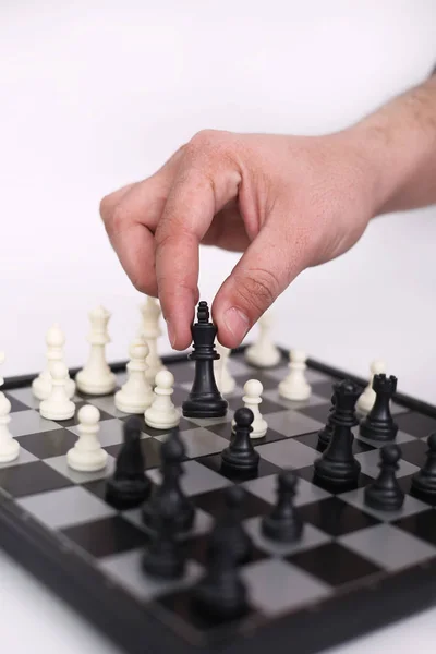 Man is playing chess. Isolated on the white background.