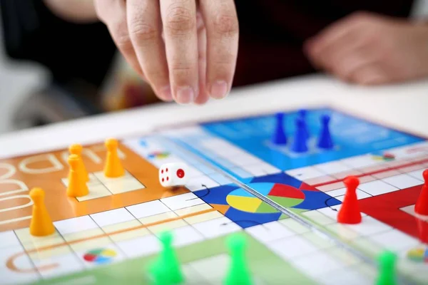 Picture of man playing ludo game. Isolated on white background.