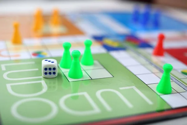 Picture of man playing ludo game. Isolated on white background.