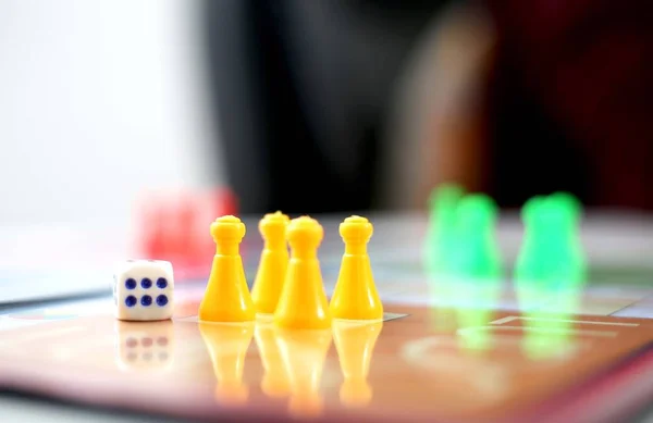 Ludo'da zar olan ludo jetonlarının yakın çekimi. Beyaz arka planda yalıtılmış.