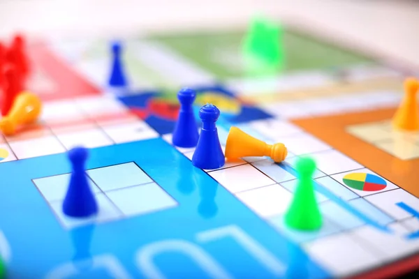 Closeup of ludo tokens on the ludo. Isolated on white background.