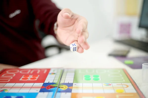 Picture of man playing ludo game. Isolated on white background..