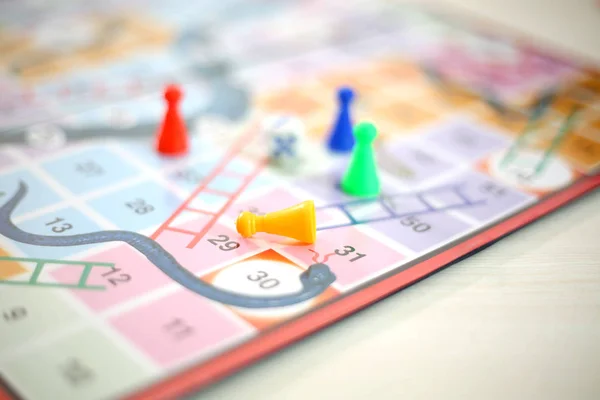 Picture of snakes and Ladders Game with tokens and dice. Isolated on white background..