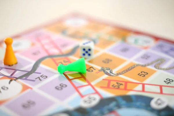 Picture of snakes and Ladders Game with tokens and dice. Isolated on white background..