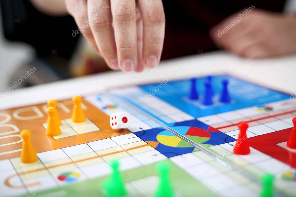 Picture of man playing ludo game. Isolated on white background.