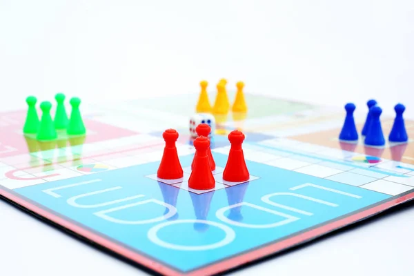 Picture of different colored tokens on ludo.  Isolated on white background.