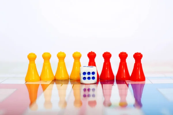 Picture of different color tokens with dice.  Isolated on white background.