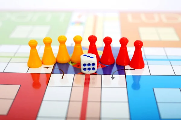 Picture of different color tokens with dice.  Isolated on white background.