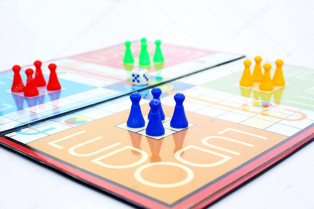   Picture of different colored tokens on ludo.  Isolated on white background.