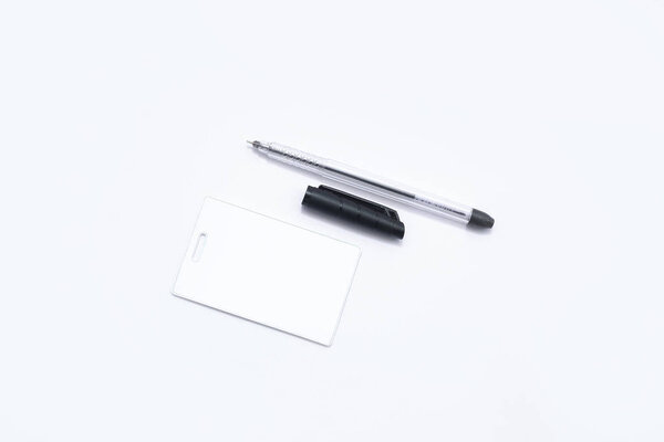 Portrait of tag card and ball pen. Isolated on the white background.