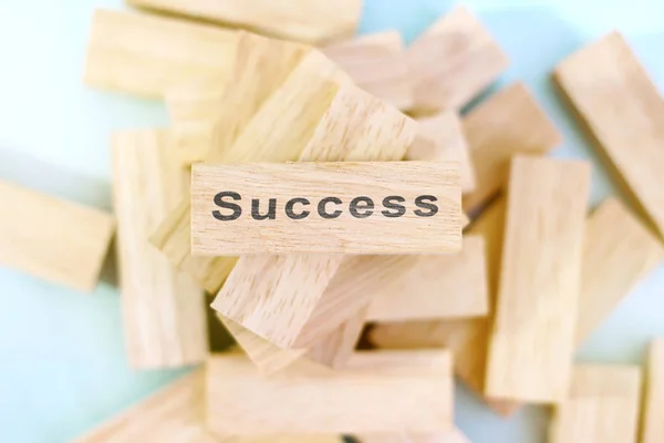 Success word written on wood block. Success text on wooden table for your design, concept.