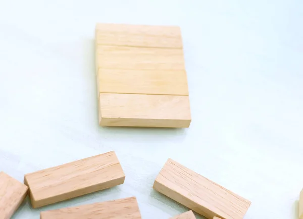 Wooden toy cubes on a wooden background.
