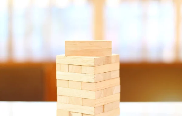 Wooden toy cubes on a wooden background.