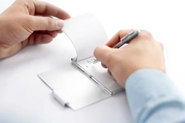 Picture of man working paperwork with pen. Isolated on white background.