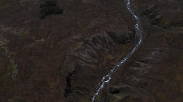 바위투성이 의산들 사이를 흐르는 작은 강을 공중에서 바라본 모습, 아이슬란드. — 비디오