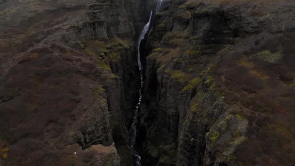 Aerial of rocky green Fjadrargljufur Canyon in Iceland with a stream waterfall — Stok Video