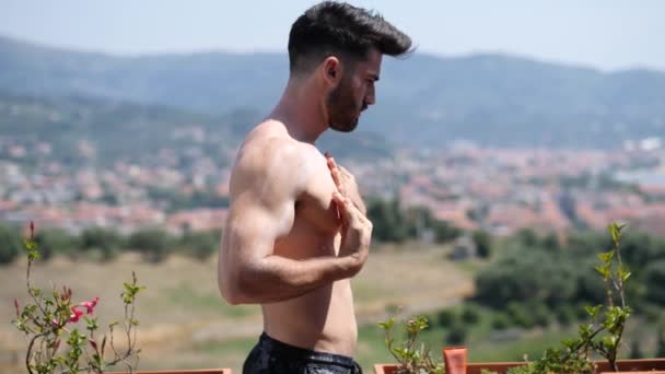 Shirtless Young Man Putting on Sunscreen Cream — Stock Video