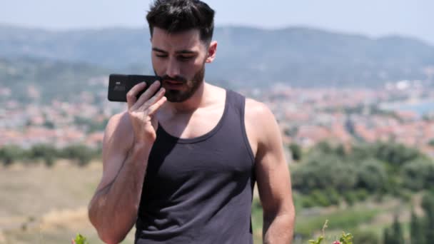 Young Handsome Man Using Smartphone Send Voice Message While Standing — Stock Video