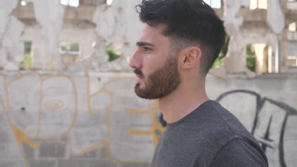 Young male walking in old abandoned building — Stock Video