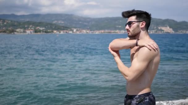 Homem colocando em creme protetor solar, na praia — Vídeo de Stock