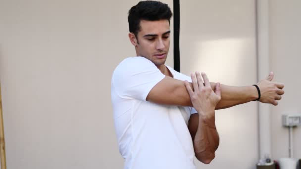 Young man doing stretching exercise outdoor — Stock Video