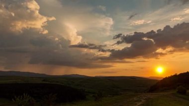 Yaz günbatımı manzarası tepeler, dağlar ve yollar bulutlar ve yağmur ile