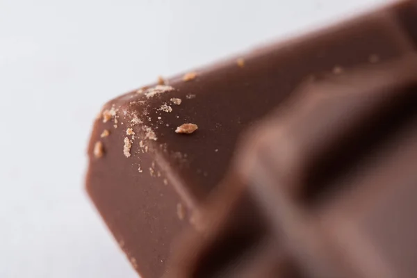 Ounces of chopped sweet chocolate, chocolate bars on a white background.