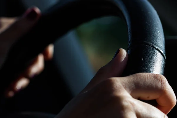 Hands of person driving a vehicle. Technology and traffic.